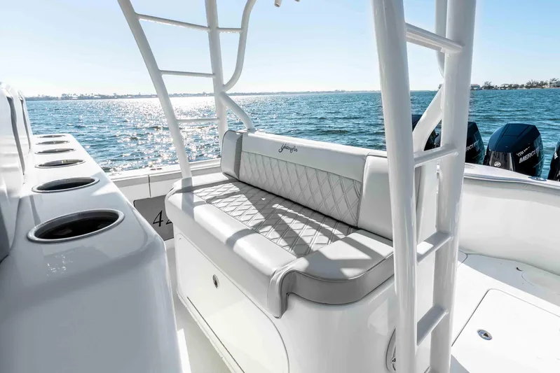  Yacht Photos Pics 2023 Yellowfin 42 Offshore boat interior with cushioned seating and ocean view.