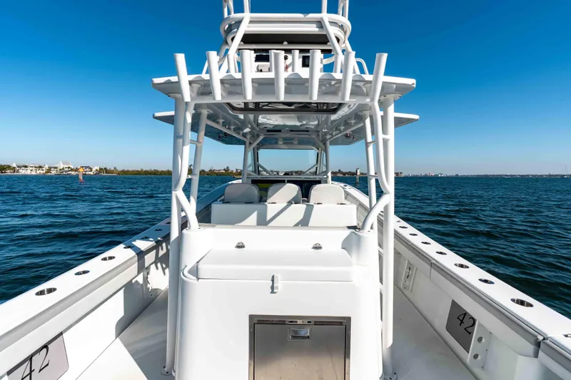  Yacht Photos Pics 2023 Yellowfin 42 Offshore boat on open water, showcasing sleek design and spacious deck.