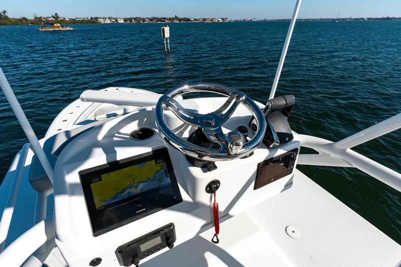  Yacht Photos Pics 2023 Yellowfin 42 Offshore boat helm with navigation system on open water.