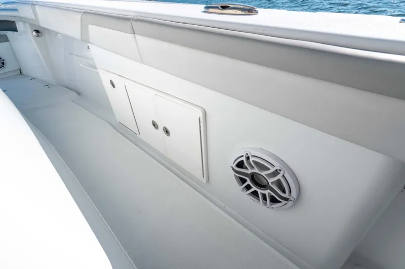  Yacht Photos Pics 2023 Yellowfin 42 Offshore boat interior with storage compartments and speaker.