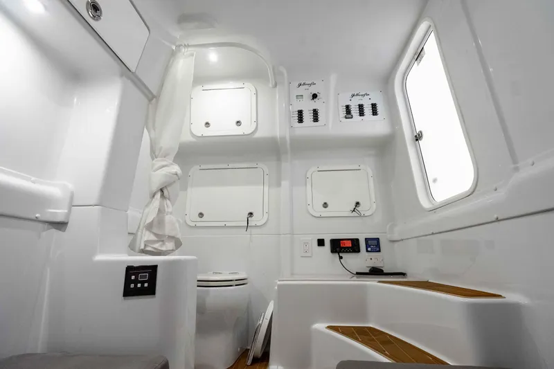  Yacht Photos Pics 2023 Yellowfin 42 Offshore boat interior with modern controls and seating.