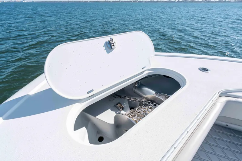  Yacht Photos Pics 2023 Yellowfin 42 Offshore boat anchor compartment open on calm water.