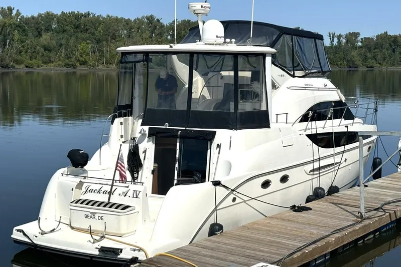  Yacht Photos Pics 2004 Meridian 459 Cockpit Motoryacht docked on calm water, rear view.