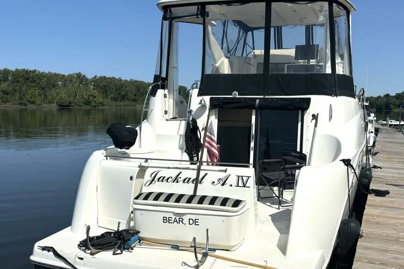  Yacht Photos Pics 2004 Meridian 459 Cockpit Motoryacht docked by a serene lake.