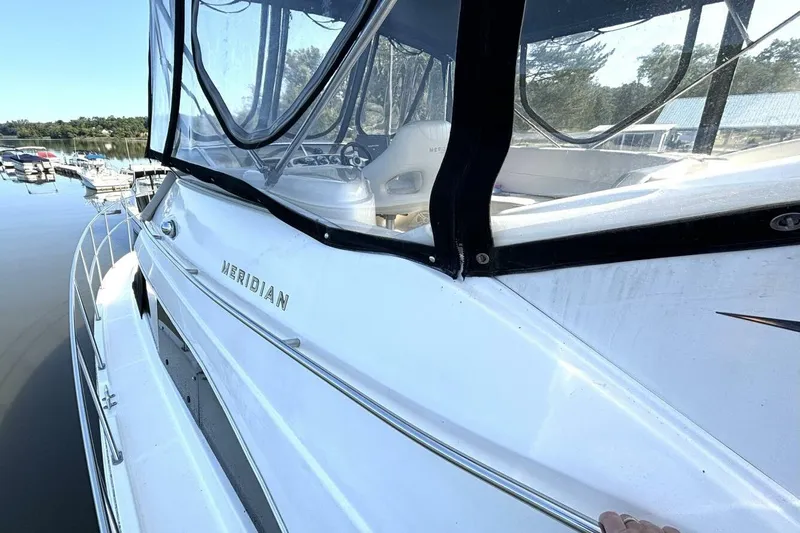  Yacht Photos Pics 2004 Meridian 459 Cockpit Motoryacht docked, showcasing sleek design and spacious cockpit area.