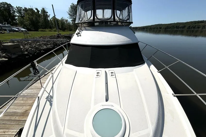  Yacht Photos Pics 2004 Meridian 459 Cockpit Motoryacht docked by a serene lake.