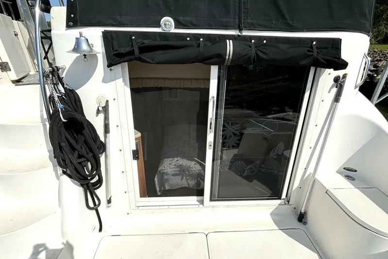  Yacht Photos Pics 2004 Meridian 459 Cockpit Motoryacht with sliding glass door and nautical decor.