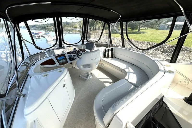  Yacht Photos Pics 2004 Meridian 459 Cockpit Motoryacht interior with helm, seating, and panoramic windows.