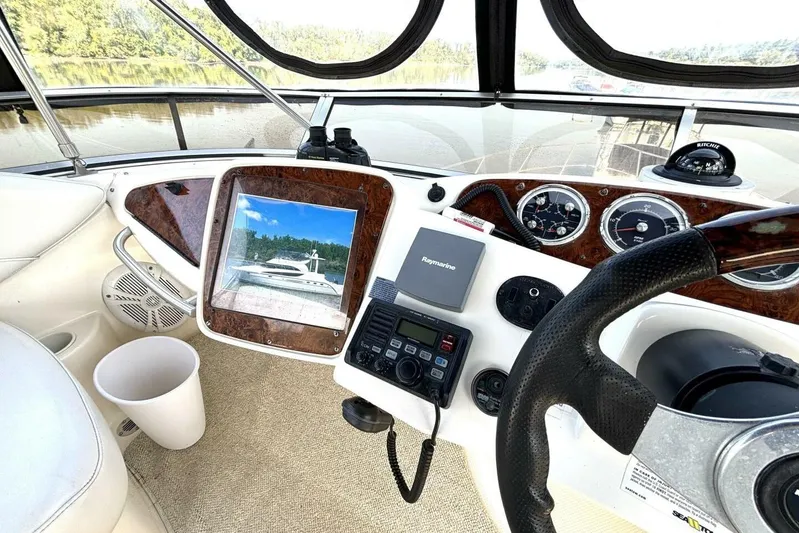  Yacht Photos Pics 2004 Meridian 459 Cockpit Motoryacht helm with navigation equipment and scenic view.