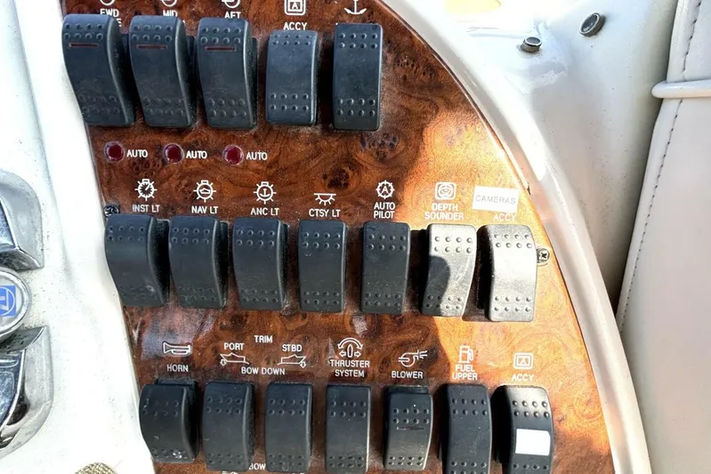  Yacht Photos Pics Control panel of a 2004 Meridian 459 Cockpit Motoryacht with various switches and labels.