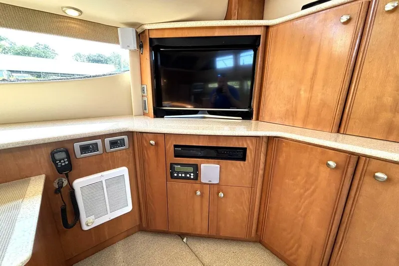  Yacht Photos Pics Luxurious interior of 2004 Meridian 459 Cockpit Motoryacht with wood cabinetry and entertainment system.