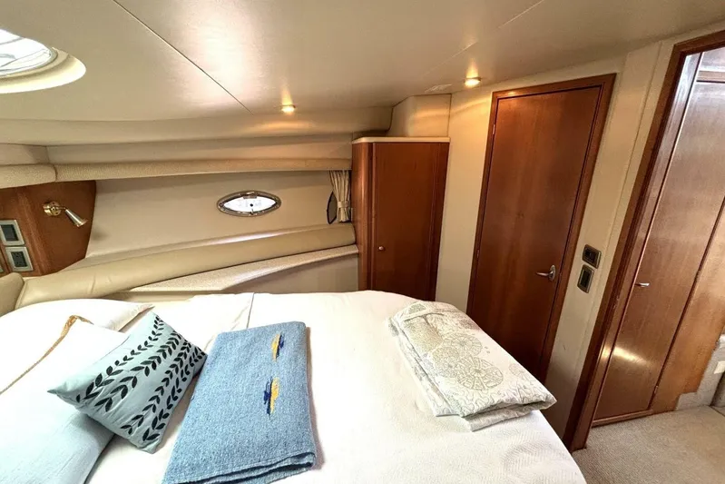  Yacht Photos Pics Luxurious cabin interior of 2004 Meridian 459 Cockpit Motoryacht with cozy bedding and wooden accents.