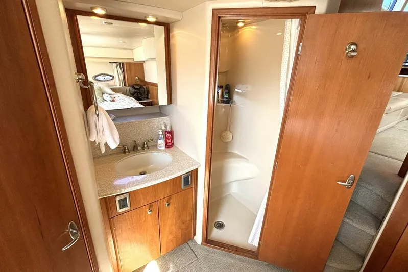  Yacht Photos Pics 2004 Meridian 459 Cockpit Motoryacht bathroom with sink, mirror, and shower.