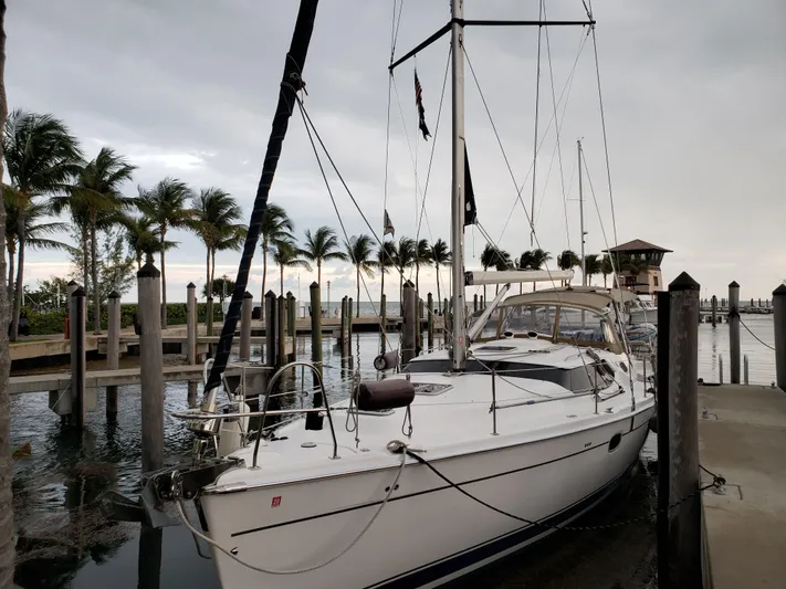 Caribbean Breeze Yacht Photos Pics 2010 Hunter 45 Deck Salon sailboat docked at a marina with palm trees.