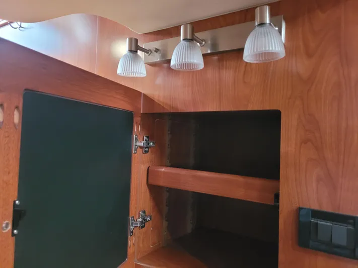 Caribbean Breeze Yacht Photos Pics Interior of 2010 Hunter 45 Deck Salon with open wooden cabinet and modern lighting.