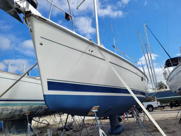 Caribbean Breeze Yacht Photos Pics 2010 Hunter 45 Deck Salon sailboat on dry dock, blue and white hull, clear sky background.