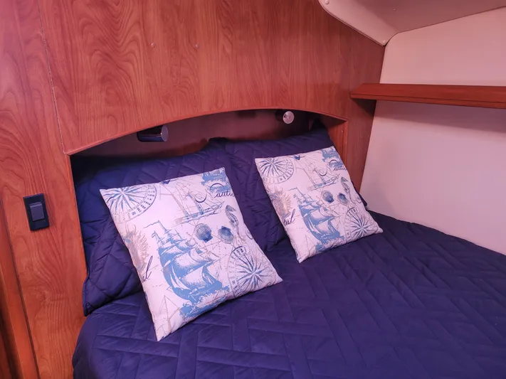Caribbean Breeze Yacht Photos Pics Cozy cabin interior of 2010 Hunter 45 Deck Salon with nautical-themed pillows.