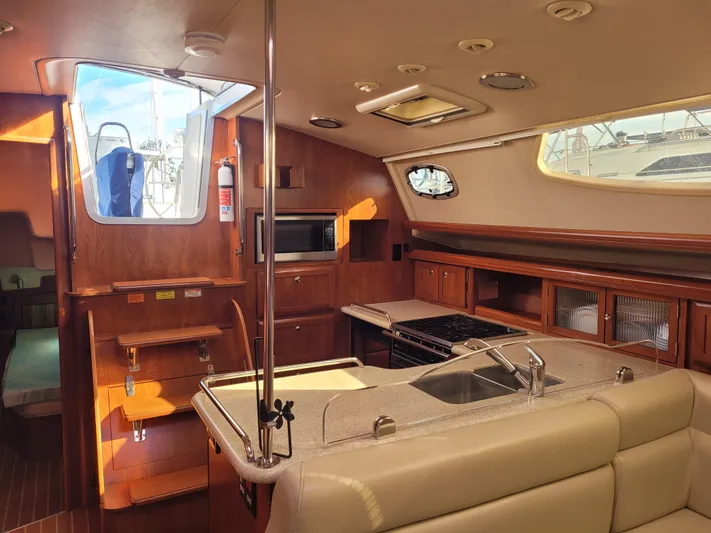 Caribbean Breeze Yacht Photos Pics Interior of 2010 Hunter 45 Deck Salon yacht with kitchen and seating area.