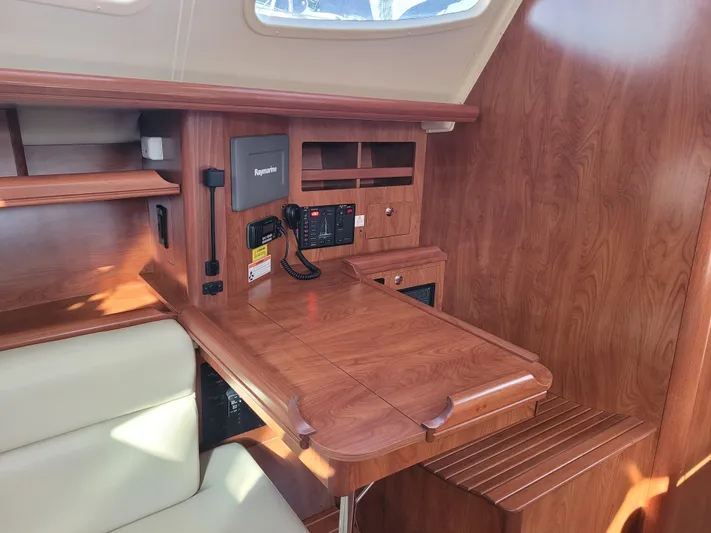 Caribbean Breeze Yacht Photos Pics 2010 Hunter 45 Deck Salon interior with navigation station and wood finish.