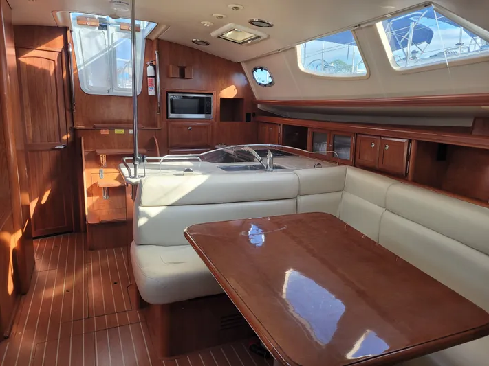 Caribbean Breeze Yacht Photos Pics Interior of 2010 Hunter 45 Deck Salon yacht with dining area and kitchen.