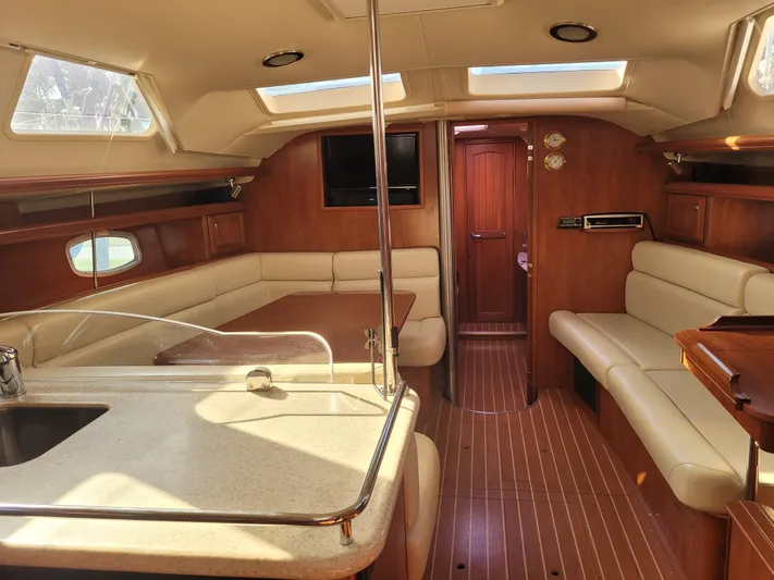 Caribbean Breeze Yacht Photos Pics Luxurious interior of 2010 Hunter 45 Deck Salon yacht with elegant wood finish and spacious seating.