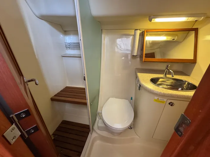 Caribbean Breeze Yacht Photos Pics 2010 Hunter 45 Deck Salon bathroom with shower, toilet, sink, and mirror.