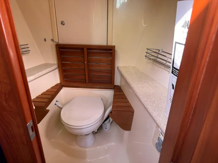 Caribbean Breeze Yacht Photos Pics Bathroom interior of 2010 Hunter 45 Deck Salon yacht with wooden accents and modern fixtures.