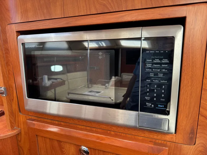 Caribbean Breeze Yacht Photos Pics Microwave in 2010 Hunter 45 Deck Salon yacht kitchen with wood paneling.