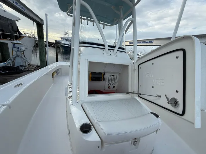  Yacht Photos Pics 2018 SeaVee 270Z boat interior with storage compartment and seating, docked at marina.
