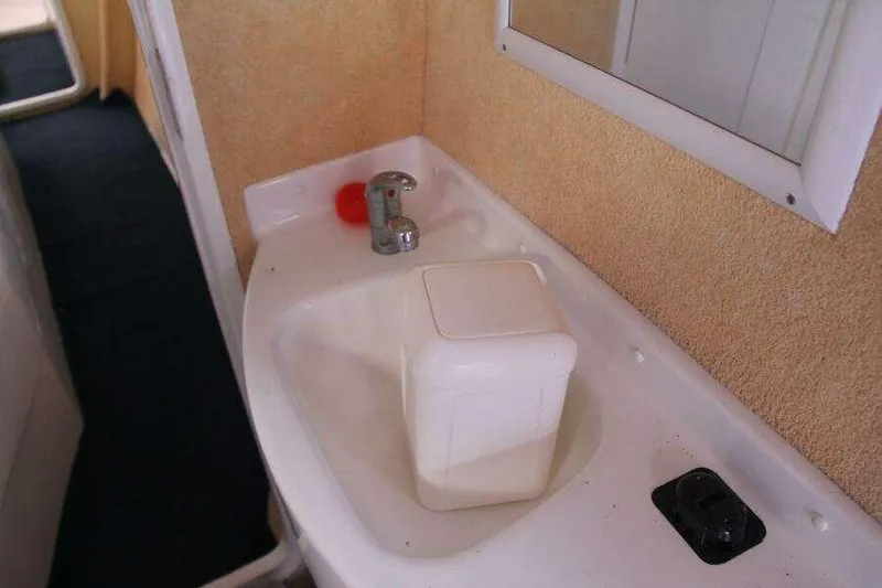 Chasing The Dream Yacht Photos Pics Sink area in 1995 Voyage Yachts Mayotte, featuring faucet and mirror.