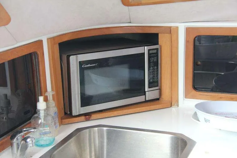 Chasing The Dream Yacht Photos Pics Microwave in 1995 Voyage Yachts Mayotte kitchen with sink and soap dispensers.