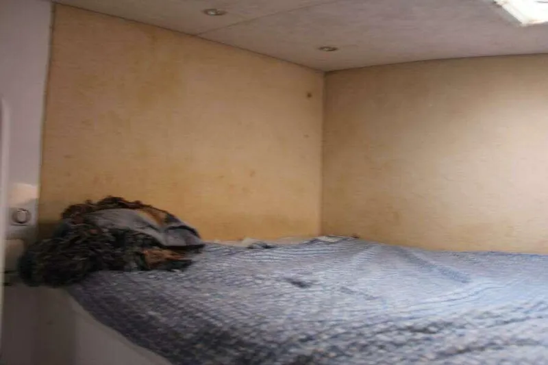 Chasing The Dream Yacht Photos Pics Cozy cabin interior of 1995 Voyage Yachts Mayotte with bed and soft lighting.