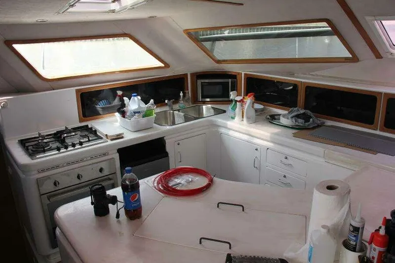 Chasing The Dream Yacht Photos Pics Interior of 1995 Voyage Yachts Mayotte kitchen with stove, sink, and storage.