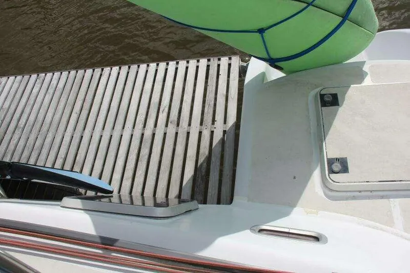 Chasing The Dream Yacht Photos Pics Deck view of 1995 Voyage Yachts Mayotte with green sail and wooden platform.