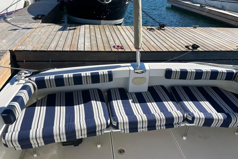 Sandpiper Yacht Photos Pics 2008 Back Cove 29 boat with striped seating at a dock.