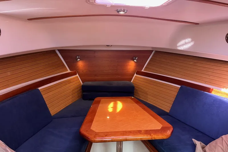 Sandpiper Yacht Photos Pics 2008 Back Cove 29 interior with blue seating and wooden accents.