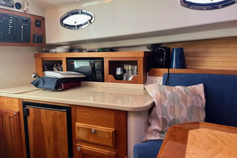 Sandpiper Yacht Photos Pics Interior of 2008 Back Cove 29 boat with kitchenette and seating area.