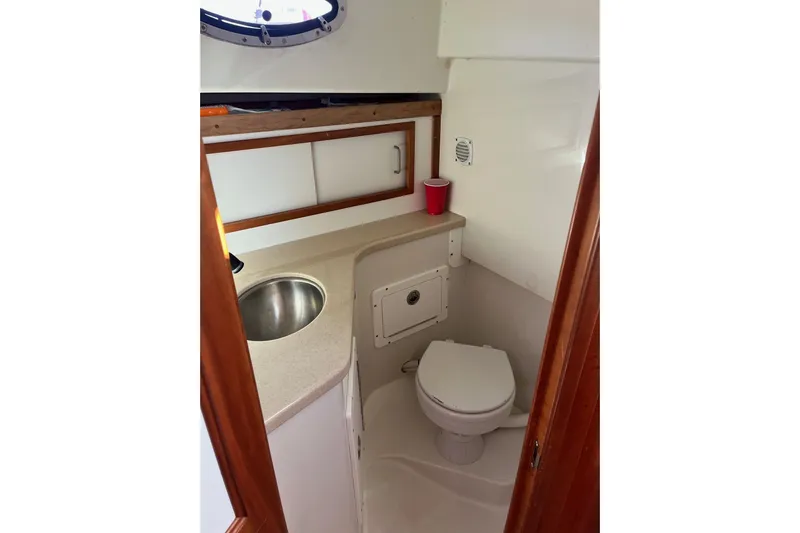 Sandpiper Yacht Photos Pics 2008 Back Cove 29 boat bathroom with sink, toilet, and storage cabinet.