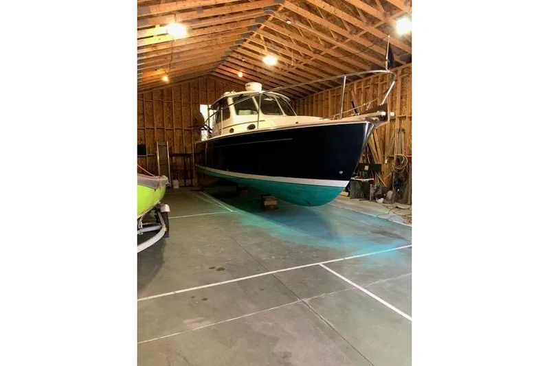 Sandpiper Yacht Photos Pics 2008 Back Cove 29 boat in a wooden garage, elevated on blocks.