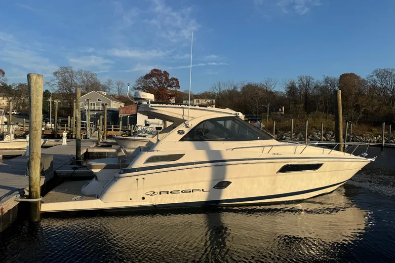  Yacht Photos Pics 2017 Regal 35 Sport Coupe docked at a marina under a clear blue sky.