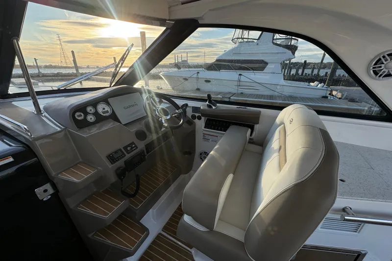  Yacht Photos Pics 2017 Regal 35 Sport Coupe interior with helm, steering wheel, and sunset view.