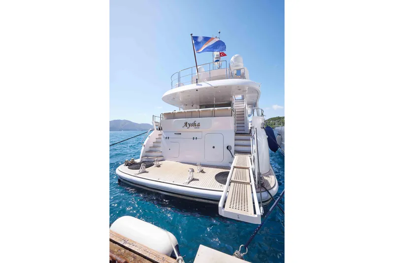 Aysha Yacht Photos Pics Luxury yacht Timmerman 26, 2012 model, docked with flag, clear blue sea.