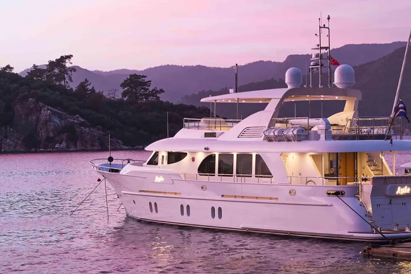 Aysha Yacht Photos Pics Luxurious 2012 Timmerman 26 yacht docked at sunset with scenic mountain backdrop.