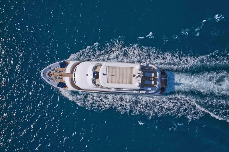 Aysha Yacht Photos Pics Aerial view of 2012 Timmerman 26 yacht cruising on blue ocean waters.