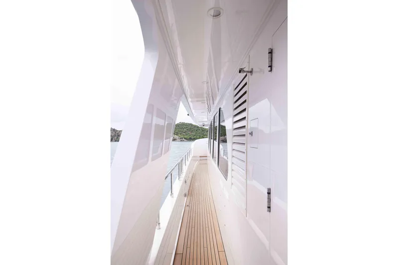 Aysha Yacht Photos Pics Side view of 2012 Timmerman 26 yacht with sleek white exterior and wooden deck.