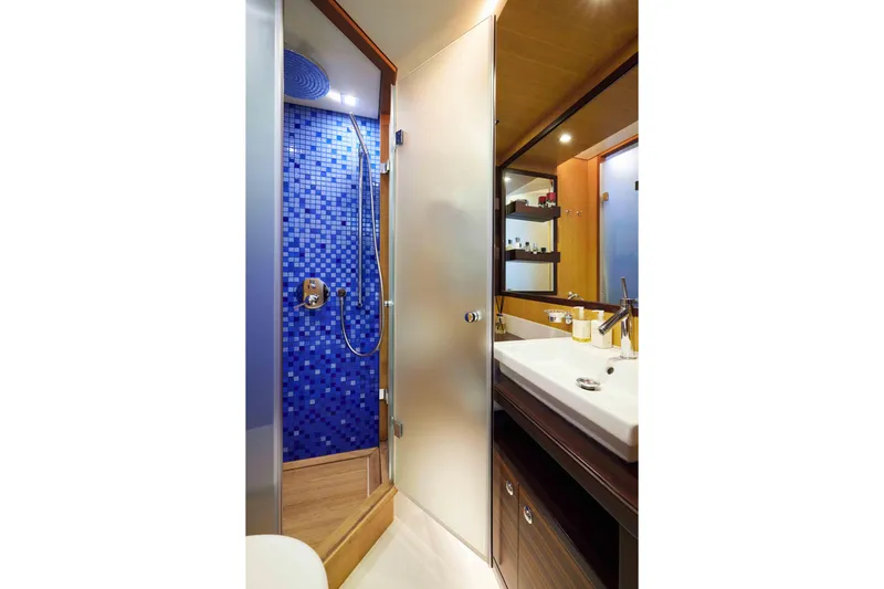 Aysha Yacht Photos Pics Luxurious yacht bathroom with blue-tiled shower, modern sink, and elegant fixtures, Timmerman 26, 2012.