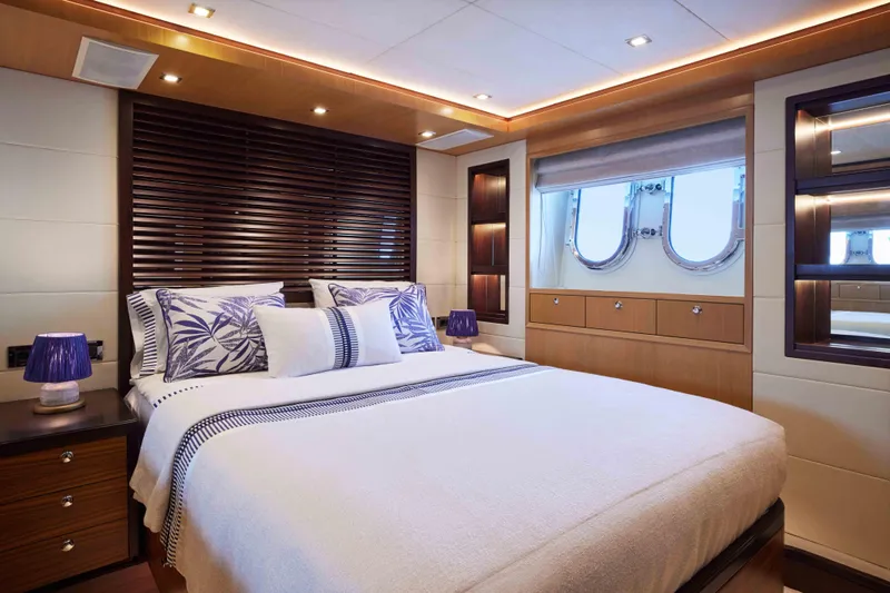 Aysha Yacht Photos Pics Luxurious bedroom interior on 2012 Timmerman 26 yacht with elegant decor and porthole windows.