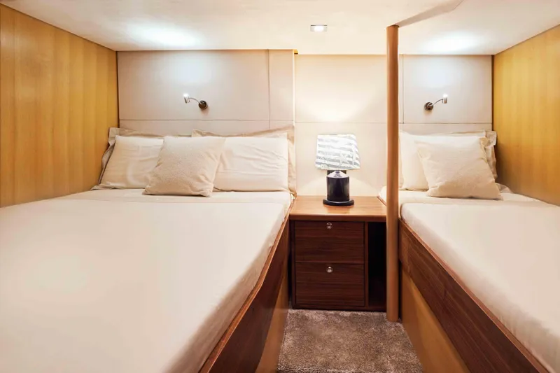 Aysha Yacht Photos Pics Luxurious twin cabin interior on 2012 Timmerman 26 yacht, featuring cozy beds and elegant lighting.