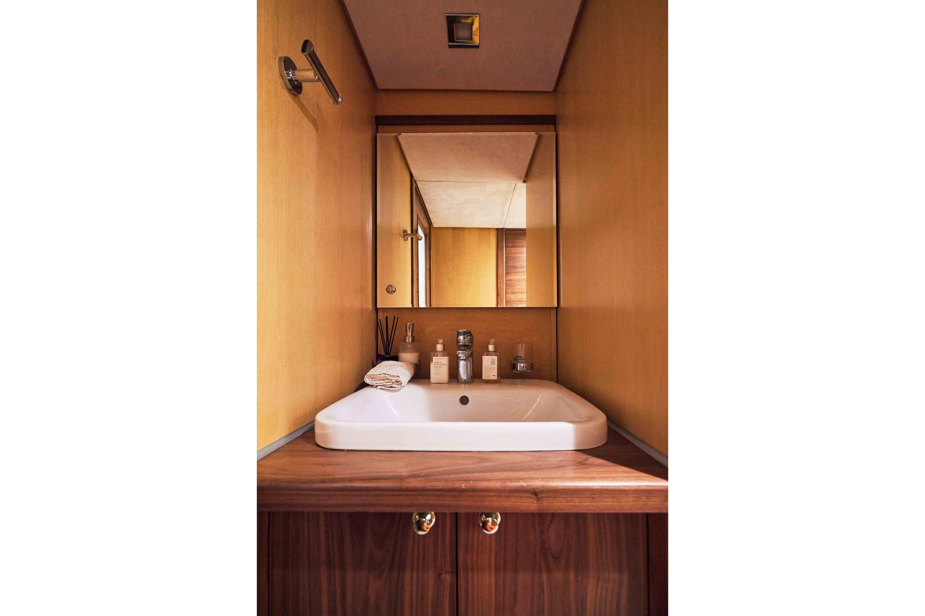 Aysha Yacht Photos Pics Compact bathroom with wooden accents, featuring a modern sink and mirror on a Timmerman 26 yacht.