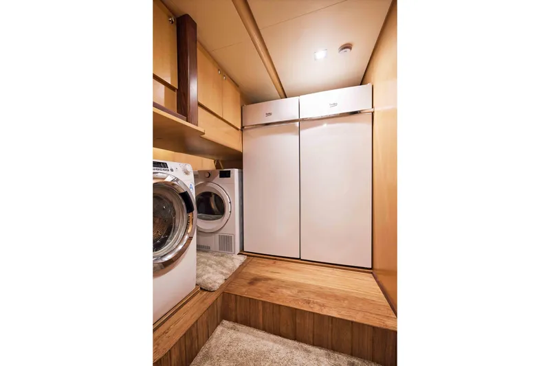Aysha Yacht Photos Pics Laundry room on Timmerman 26 yacht, 2012 model, featuring washer, dryer, and storage cabinets.